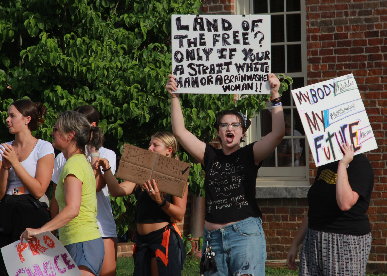People chant 'we have a voice and it’s pro-choice' as they march around the Historic Courthouse during the abortion and women’s rights rally on Monday in Pittsboro. Many cars that drove by honked in support, while some drivers in the loop shouted profanities and flipped off the protesters as they went by.